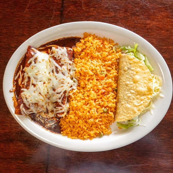 A Tacos A La Diabla plate with cheesy enchiladas, Mexican rice, and a crispy taco.