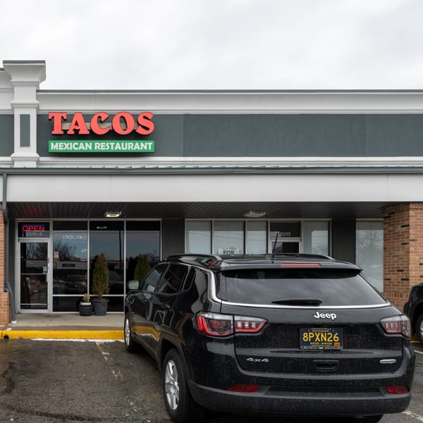 Exterior of Tacos A La Diabla, a Mexican restaurant, with a black Jeep parked in front.